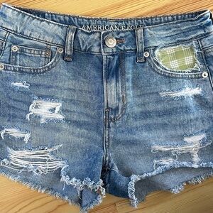 Upcycled American Eagle size 0 distressed denim shorts with Pakala print pocket
